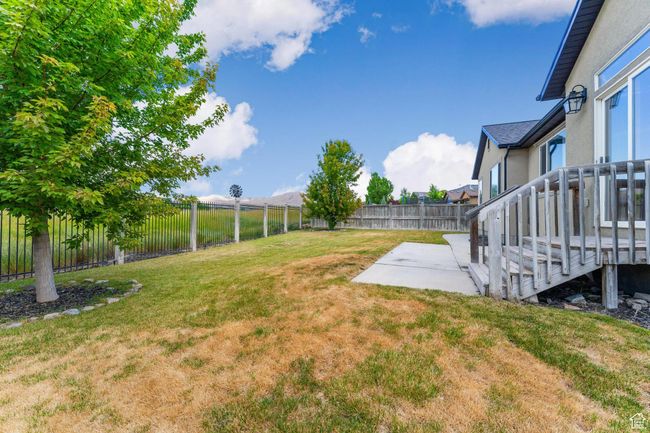 Fenced backyard featuring a patio looking onto The Ranches Golf Course | Image 39