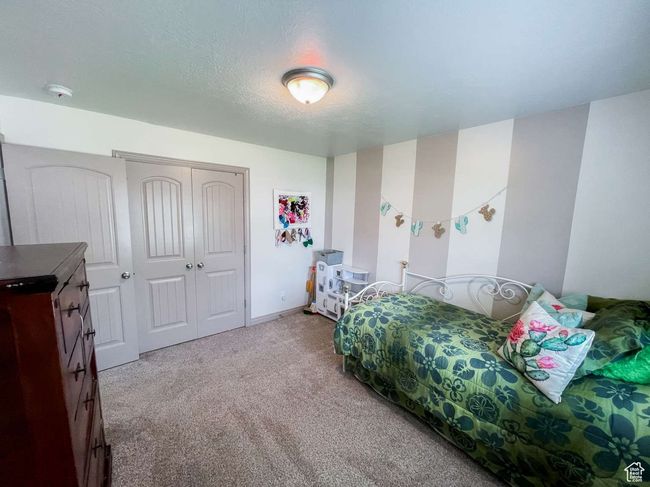 Carpeted bedroom with a closet and baseboards | Image 4