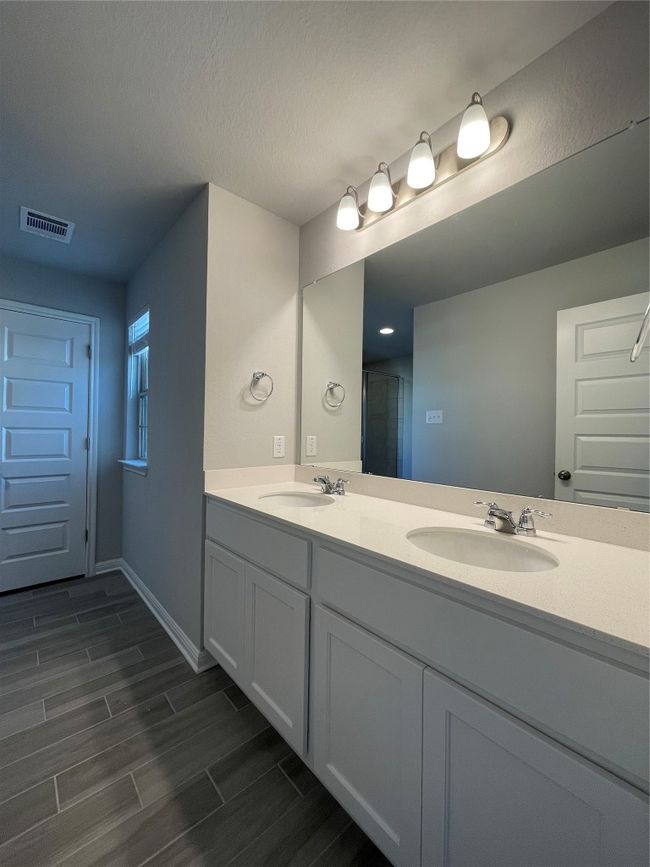 Bathroom with double vanity and wood finished floors | Image 15