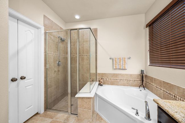 A very relaxing tub and large shower. You have a linen closet just across from the shower. Double doors leading into the primary closet. | Image 22