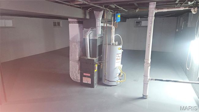 basement with water heater and heating unit | Image 14