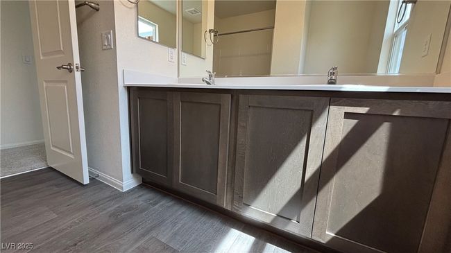 Full bath with vanity, visible vents, wood finished floors, and baseboards | Image 19