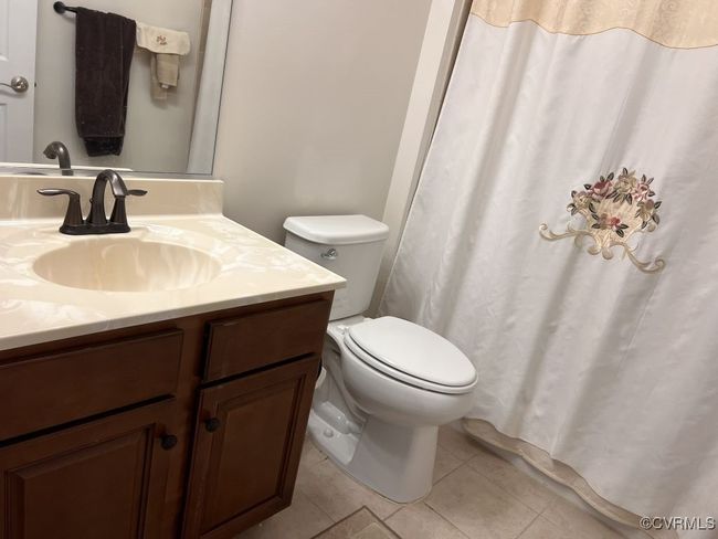 Bathroom with vanity, toilet, and tile patterned floors | Image 40