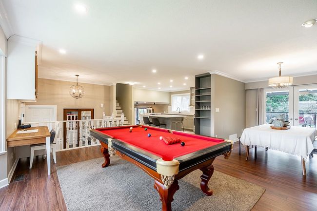Main living room with dark wood-style flooring, ornamental molding, baseboards, and recessed lighting | Image 12