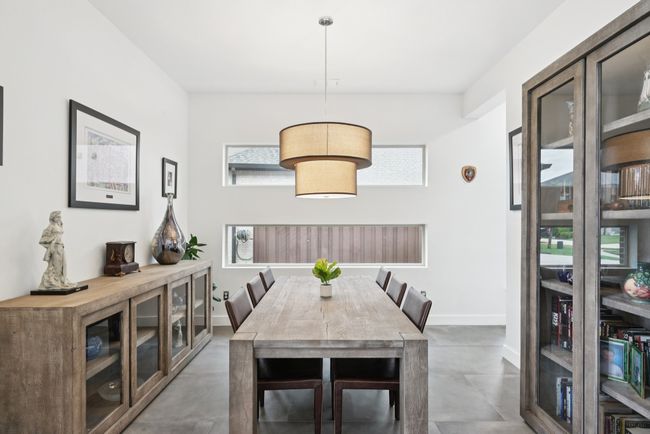Dining area with finished concrete floors and baseboards | Image 5