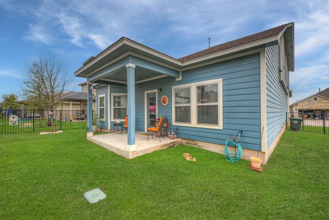 Back of house with a patio area, fence, and a lawn | Image 32