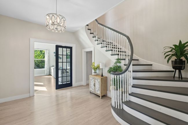 Foyer with stairs, wood finished floors, a chandelier, and baseboards | Image 33