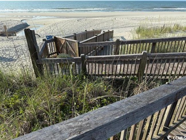 Wooden deck featuring view of water and beach | Image 6