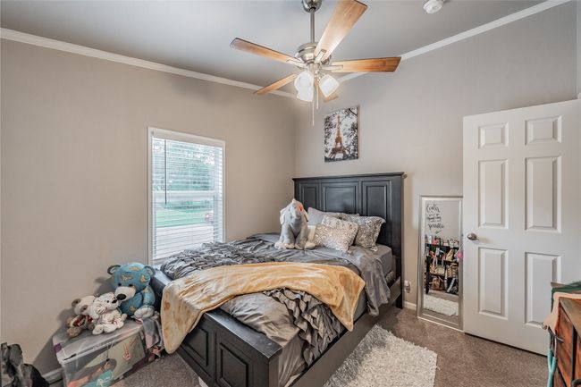 Carpeted bedroom with crown molding and ceiling fan | Image 25