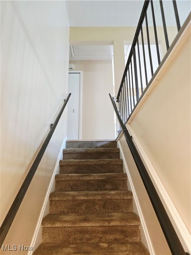 Stairs with attic access and carpet floors | Image 18