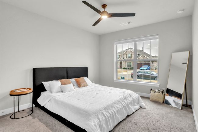 Carpeted bedroom with a ceiling fan, baseboards, and visible vents | Image 18