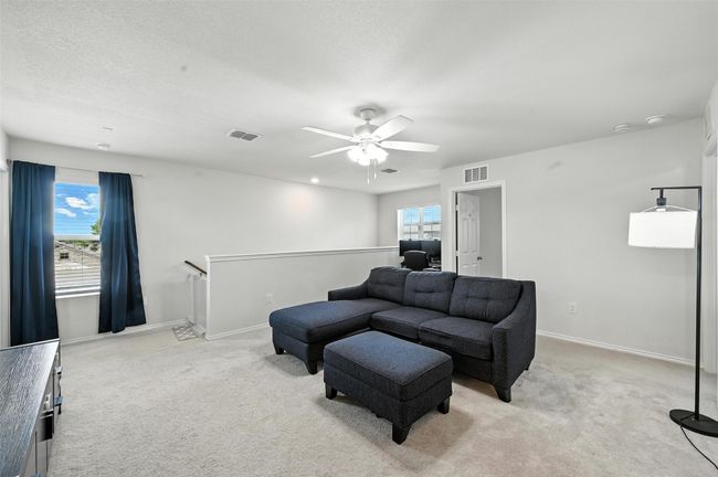 Living area with light colored carpet and a ceiling fan | Image 20