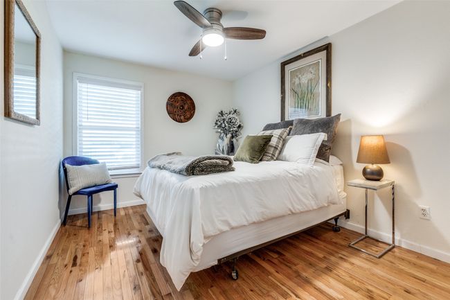 Bedroom with light wood-style flooring and a ceiling fan | Image 10