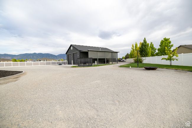 View of side of home featuring a mountain view, a detached garage, and an outbuilding | Image 78