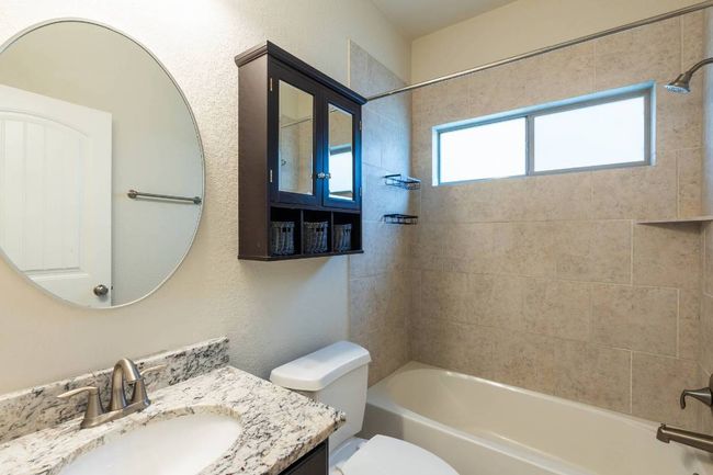 Full bathroom conveniently located between the two secondary bedrooms. | Image 29
