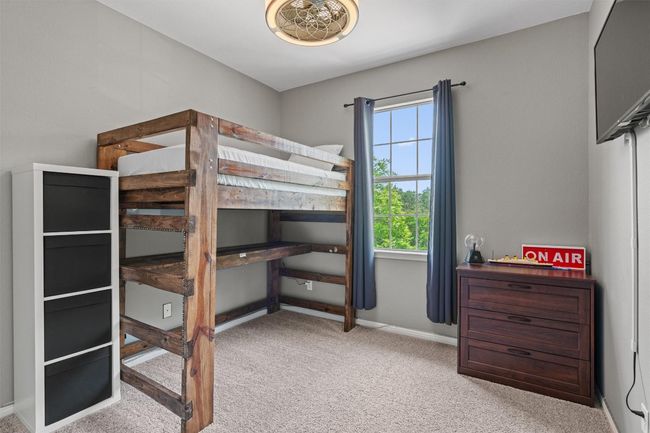 Secondary bedroom with ceiling fan. | Image 30