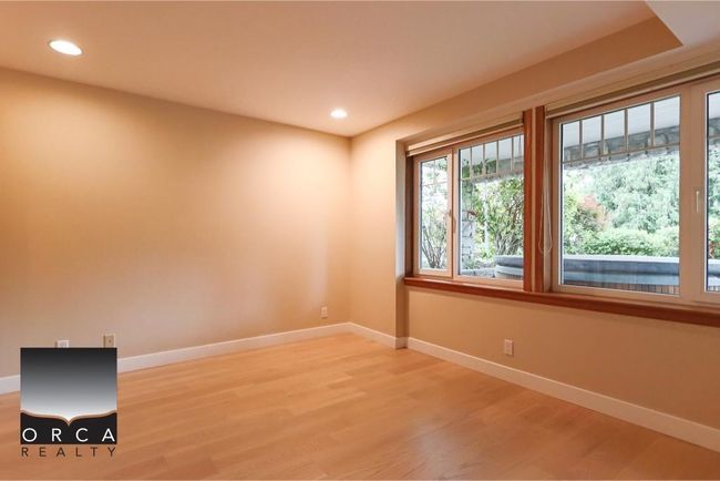 Empty room with light wood-style flooring and recessed lighting | Image 35
