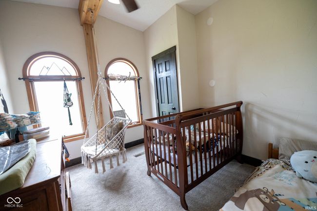 bedroom with light carpet, baseboards, and vaulted ceiling | Image 8