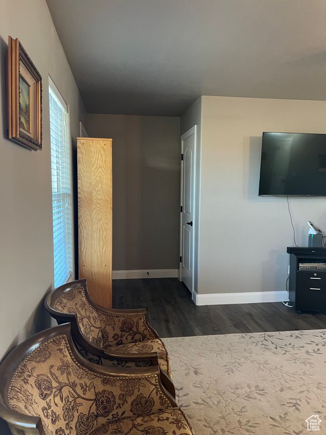Living area featuring dark wood-type flooring and baseboards | Image 35