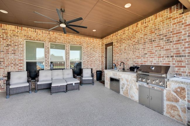View of patio / terrace featuring a ceiling fan, an outdoor kitchen, and outdoor lounge area | Image 6