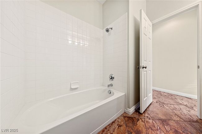 Bathroom featuring shower / tub combination and baseboards | Image 23
