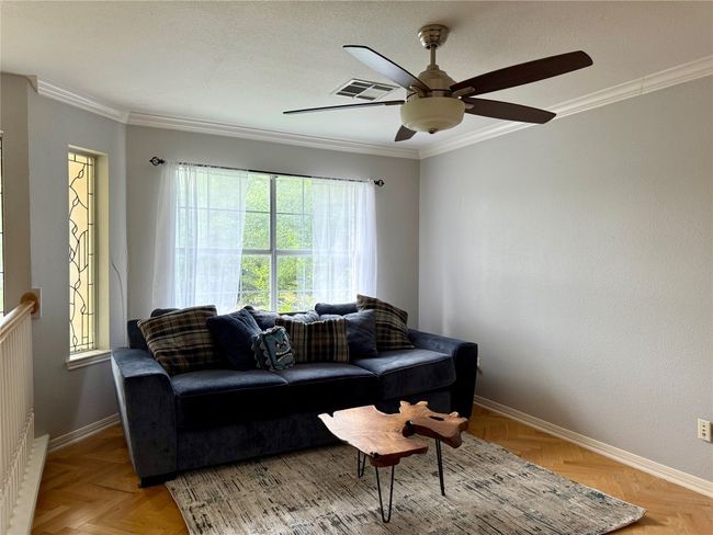 Living area featuring baseboards, visible vents, ornamental molding, and ceiling fan | Image 32