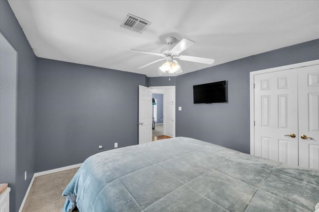 Carpeted bedroom featuring a ceiling fan, baseboards, and a closet | Image 14