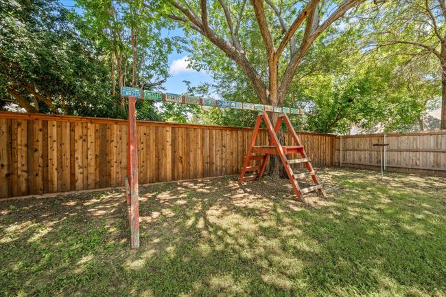 Additional view of the backyard grassy area. Notice the recently updated board-on-board privacy fence! | Image 11