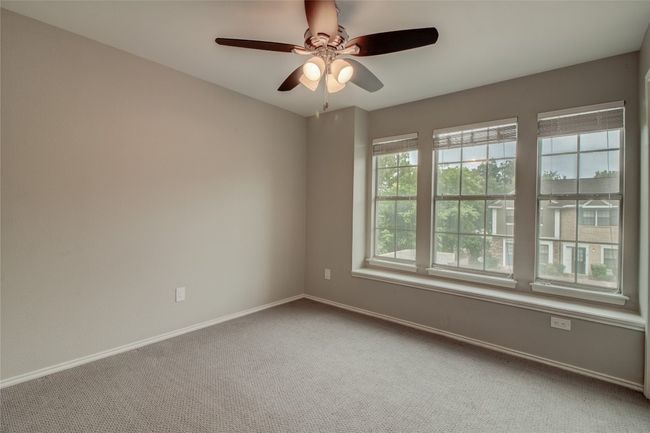 Carpeted spare room with baseboards and a ceiling fan | Image 24