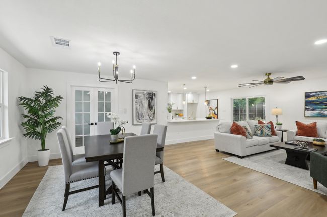 Dining room with visible vents, baseboards, recessed lighting, light wood-type flooring, and an inviting chandelier | Image 4