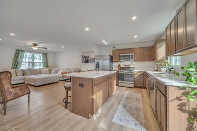 beautiful kitchen with island and white quartz counters | Image 3