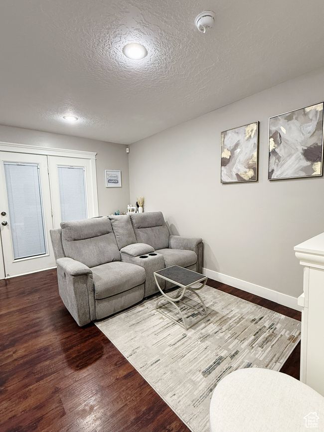 Living area featuring wood finished floors, a textured ceiling, and recessed lighting | Image 15