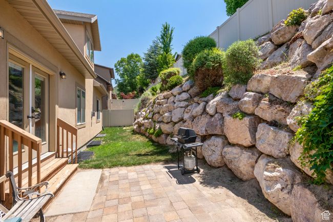 Fenced backyard featuring a patio area and a grill | Image 26