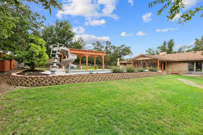 View of green lawn featuring an outdoor pool | Image 33