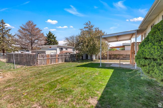 View of yard with a fenced backyard and a patio area | Image 26