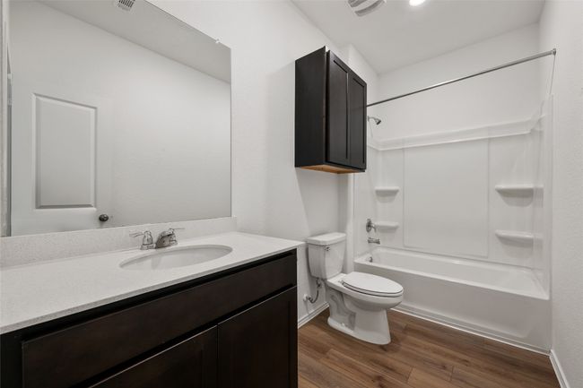 Full bath featuring wood finished floors, vanity, and tub / shower combination | Image 28