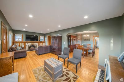 Living room featuring an inviting chandelier and light hardwood / wood-style flooring | Image 3