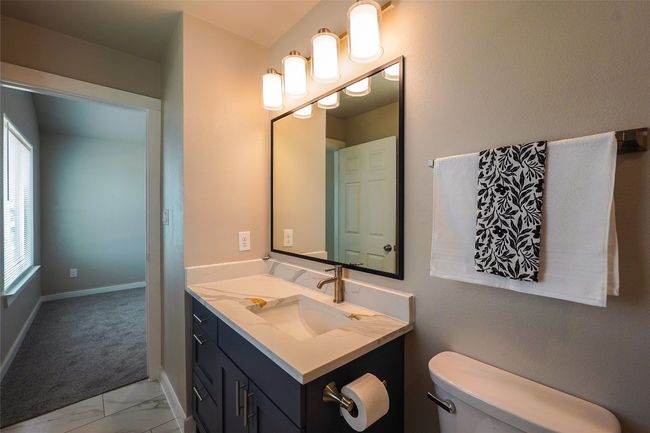 Bathroom featuring vanity and marble look tiles | Image 29