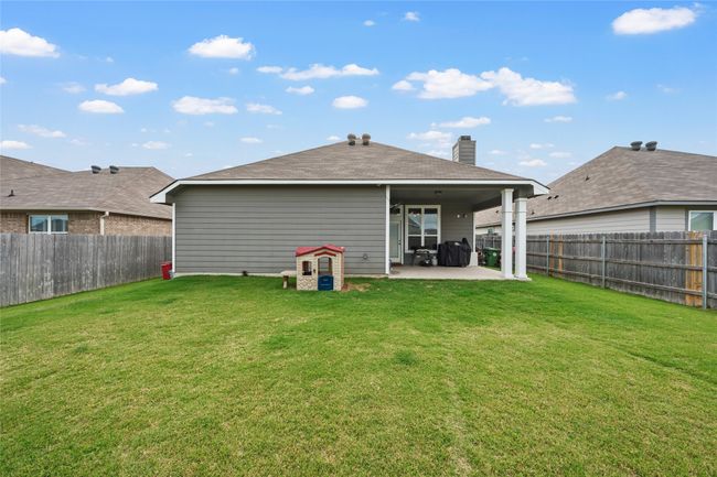 Rear view of house with a patio area and a chimney | Image 23