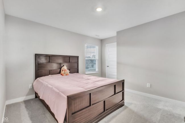 bedroom with light colored carpet and baseboards | Image 26