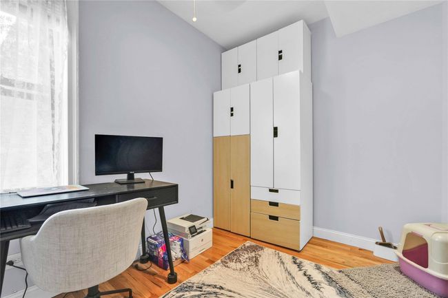Home office with light wood-style flooring, vaulted ceiling, and baseboards | Image 19