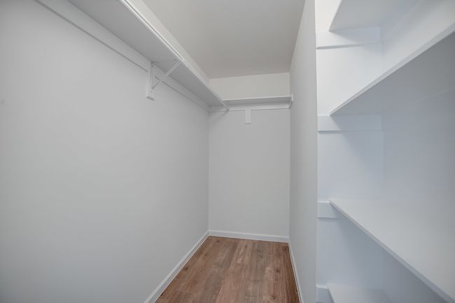 Spacious closet featuring light hardwood / wood-style flooring | Image 4