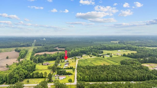 Aerial view of sparsely populated area with a heavily wooded area | Image 37