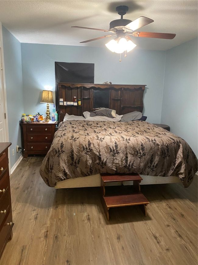 Bedroom featuring wood finished floors, baseboards, and ceiling fan | Image 11