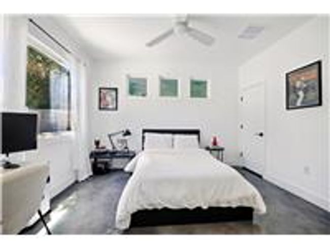 Bedroom on main floor with finished concrete floors, and ceiling fan | Image 8