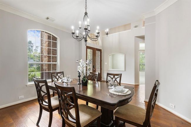 Formal dining room offers views to the front and an access hall to the kitchen at back of room. | Image 6