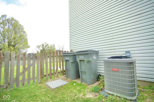 exterior details featuring central AC and fence | Image 43