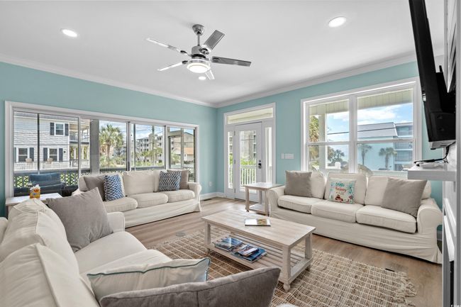 Living area featuring crown molding, wood finished floors, ceiling fan, and recessed lighting | Image 6