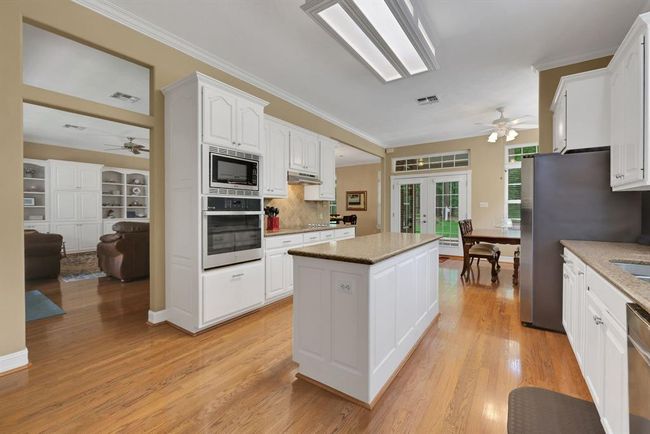 Kitchen leads out breakfast nook and to backyard | Image 18