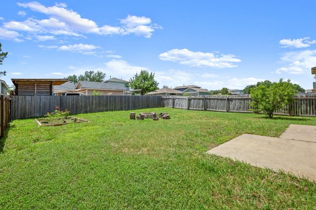 Fenced backyard featuring a patio area, fire pit and garden | Image 22